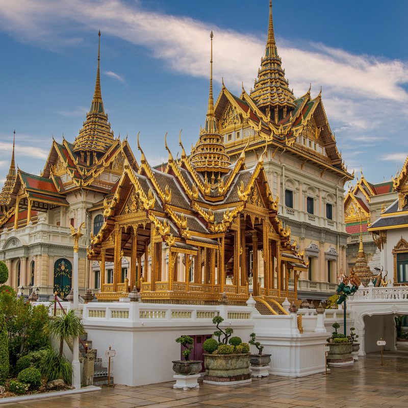 The golden spires and tiered roofs of the Grand Palace in Bangkok.