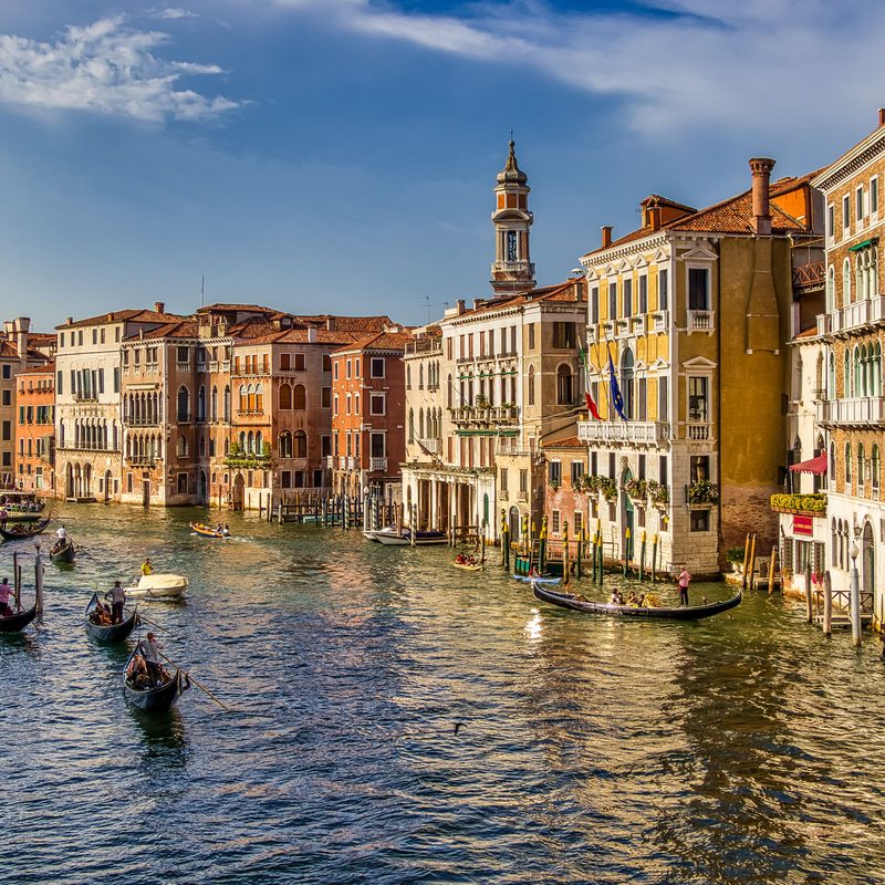 Gondolas on the Grand Canal in Venice, lined with painted palazzi.
